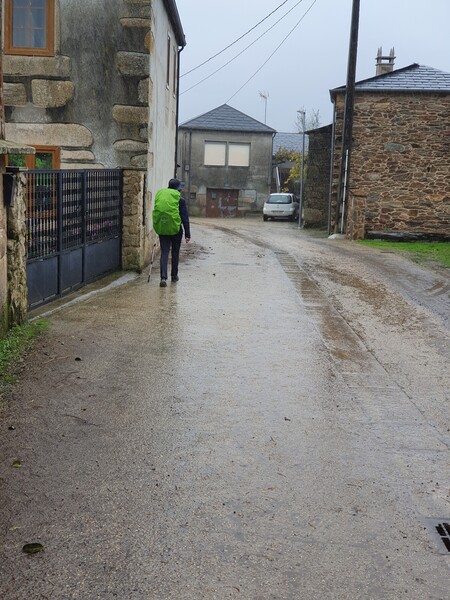 Walking in rain through Ligonde. The camera does not catch the drops very well. The lady in front is Swiss and began her journey in Switzerland.